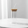 Heat resistant coffee glass with a straw and cover, perfect for travels